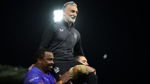 Ricky Pellow is carried off the field on the shoulders of his players