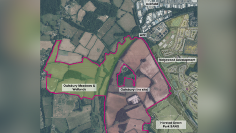 A map outlining the proposed site for 1,700 new homes in Uckfield, East Sussex. The site is marked 'Owlsbury', to the west of which are meadows and wetlands. The A22 runs alongside the site into Uckfield, which is to the north of the proposed site.