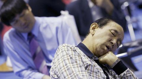 Elderly South Korean job seekers sleep during an elderly persons' job fair on September 23, 2005 in Seoul, South Korea.