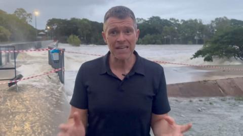 Simon Atkinson stands in front of flooded pathways