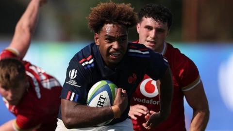 Simeli Daunivucu of France breaks away for a try