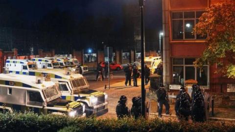 Officers and police land rovers pictured at Nailors Row