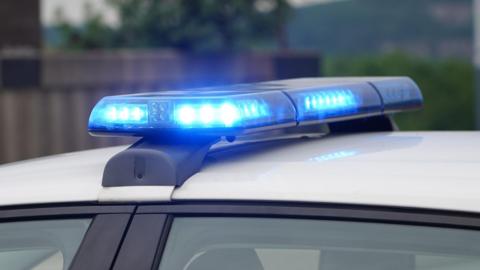 A set of blue emergency service vehicle lights on top of a white roof.