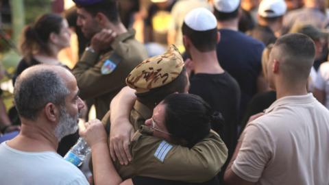 Two Israelis hug