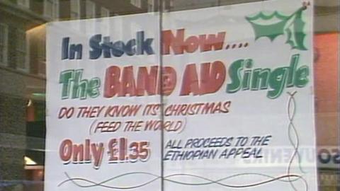 A sign in a shop window advertising the Band Aid single.