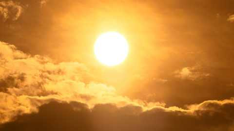 The sun in the sky with some clouds