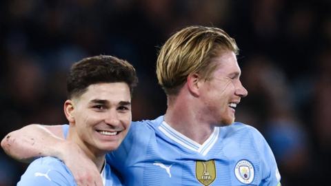 Julian Alvarez celebrates with Kevin De Bruyne after scoring his second goal for Manchester City at Etihad Stadium