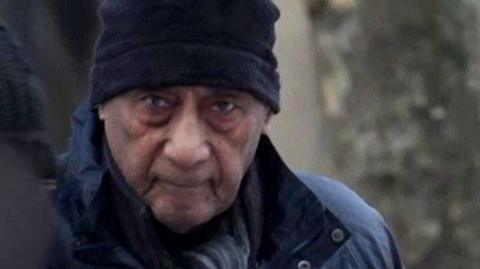 Malcolm Phillips head and shoulders image wearing a coat and hat while arriving at court in a grab from footage