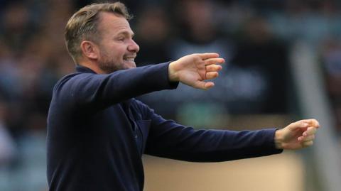 Tom Cleverley standing pitch side during Plymouth Argyle's match against Coventry City.