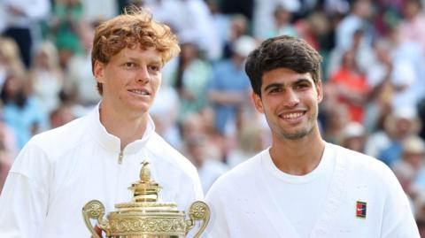 Jannik Sinner and Carlos Alcaraz pose with Wimbledon trophies