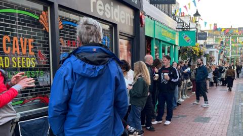 Queues waiting for the Nick Cave presale to open. People are lined up outside Resident Music in Kensington Gardens, Brighton and Hove.