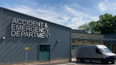 A grey building with the words Accident and Emergency Department.