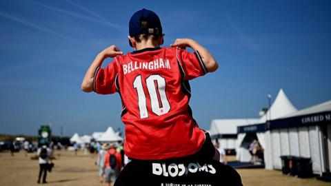 A young England fan takes in a practice round at the Open championship