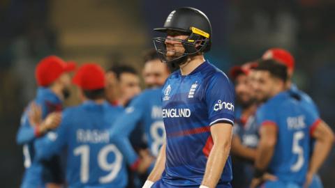 England's Dawid Malan walks off as Afghanistan celebrate his wicket
