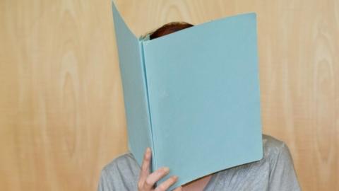 Andrea G hiding her face as she arrives for the opening of her trial at the district court of Coburg, (12 July 2016)