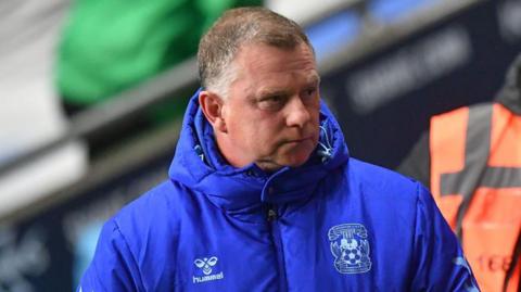 Mark Robins watches on from the touchline during a Coventry City game