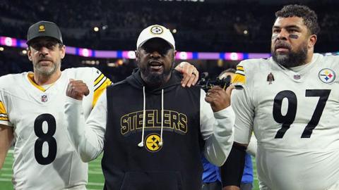 Head coach Mike Tomlin walks off the field with Aaron Rodgers and Cameron Heyward of the Pittsburgh Steelers after beating the Detroit Lions