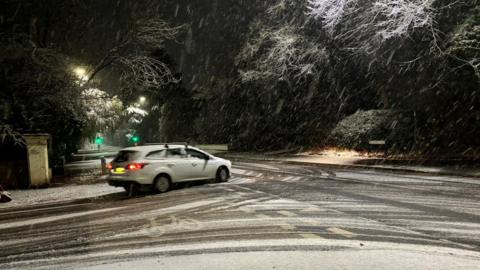 car at a junction in snow