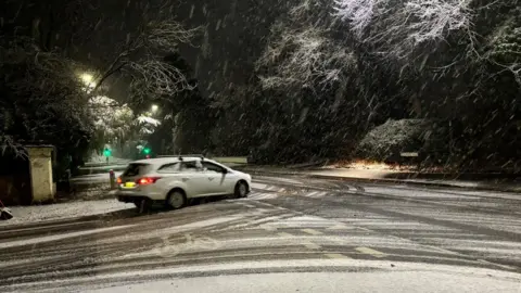 car at a junction in snow