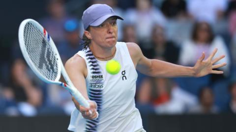 Iga Swiatek hits a forehand