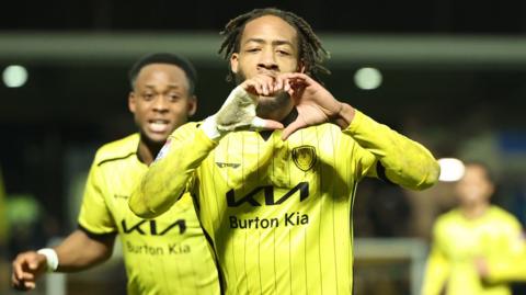 Burton Albion goalscorer Rumarn Burrell forms a heart with his fingers