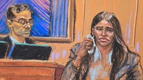 A courtroom sketch of Cassie Ventura, in a white blazer and striped jacket, crying on the stand in court. To her left is Judge Arun Sumbramanian, in black robes and glasses.