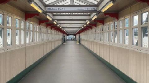 A footbridge that at Nottingham railway station with signs showing directions to different platforms