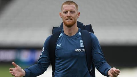 England captain Ben Stokes pictured wearing a backpack and his arms outstretched by his side