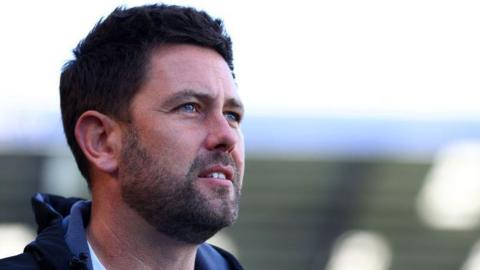 Oxford United manager Des Buckingham looks on from the touchline against Portsmouth