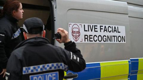 Police officers man a live facial recognition van on the High Street in December 2024 in Southend, England.