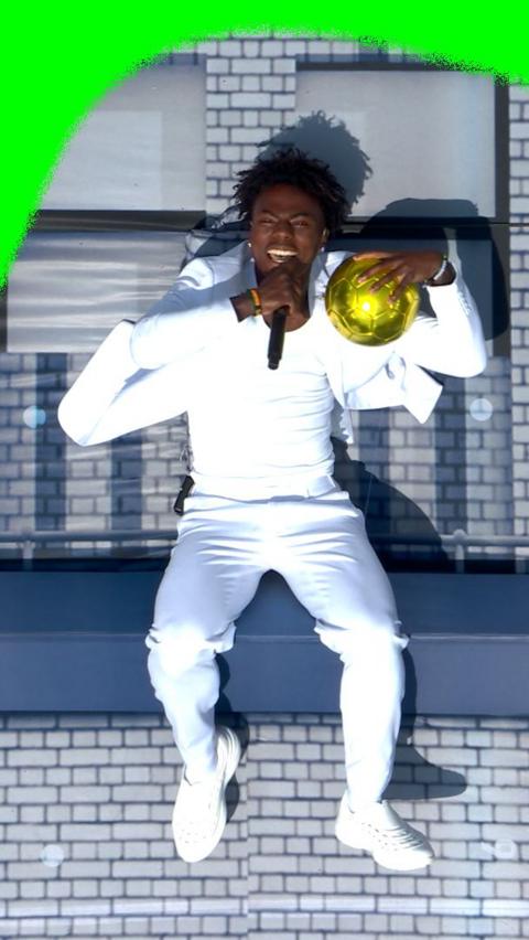 IShowSpeed holding a golden ball and a microphone at the World Cup closing ceremony.