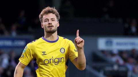 Magnus Westergaard celebrates scoring a goal for Wycombe