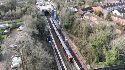 An overhead view of Moseley Village station. A train can be seen on the platform.