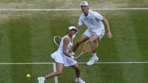 Aryna Sabalenka hits a backhand
