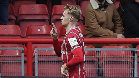 Tommy Conway runs with his finger up after scoring a penalty