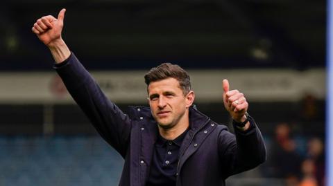John Mousinho celebrates