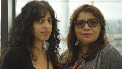 Mariam Kalim has a nose piercing and wearing a black top and is standing next to her mother Zobia Kalim who is wearing a grey cardigan 