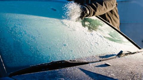 Person de-icing car