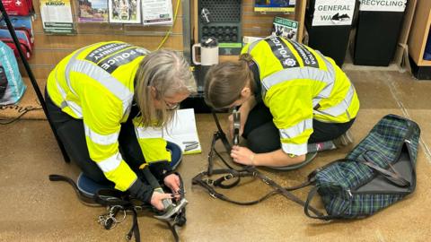 Police officers tack marking equestrian equipment including a bridle.
