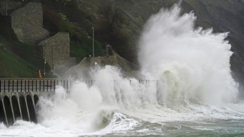 Waves crash over the promenade during rain and strong winds in Folkestone, Kent. The Met Office has issued yellow weather warnings for wind over the coming days.