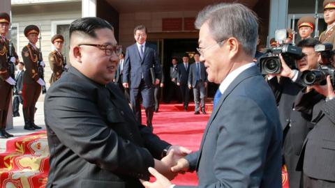 South Korean President Moon Jae-in (R) shakes hands with North Korean leader Kim Jong-un during their summit at the truce village of Panmunjom, North Korea on May 27, 2018