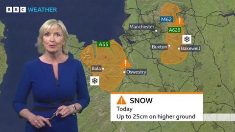 Carol Kirkwood stands in front of a weather map of the UK showing two amber warning areas