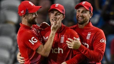 Harry Brook (C), Chris Woakes (L) and Liam Livingstone (R) of England celebrate a wicket