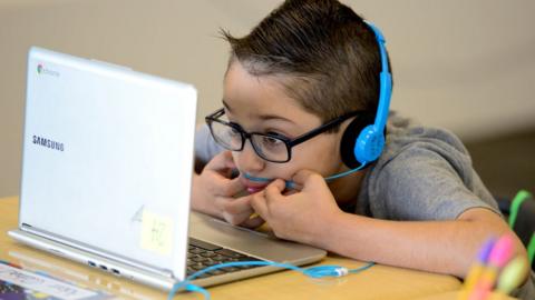 Chromebooks are hit by sunlight on a classroom floor in this 2020 file photo