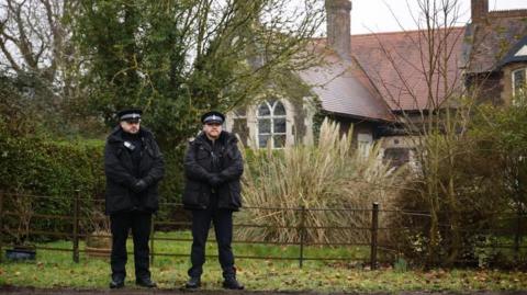 Police officers outside Wood Farm, a property on the Sandringham Estate