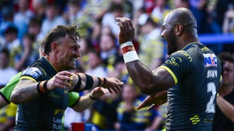 Maika Sivo celebrates a try with Leeds team-mate Chris Hankinson 