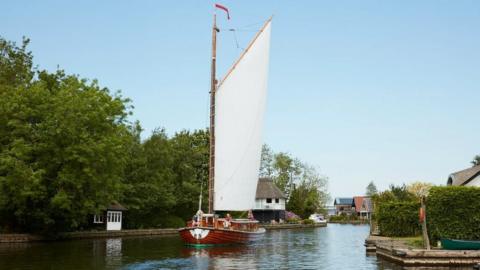 One of Wherry Yacht Charity's wherries on the River Bure, Norfolk