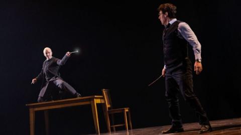 Tom Felton on the left as Draco Malfoy and John Skelley as Harry Potter.