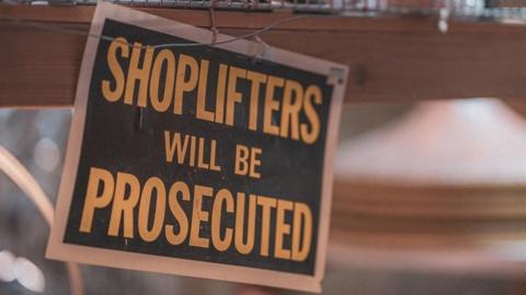 Sign reading 'shoplifters will be prosecuted'