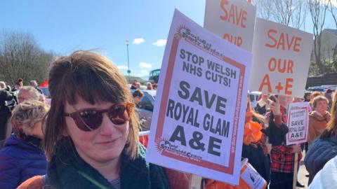 Protester outside health board meeting on Thursday